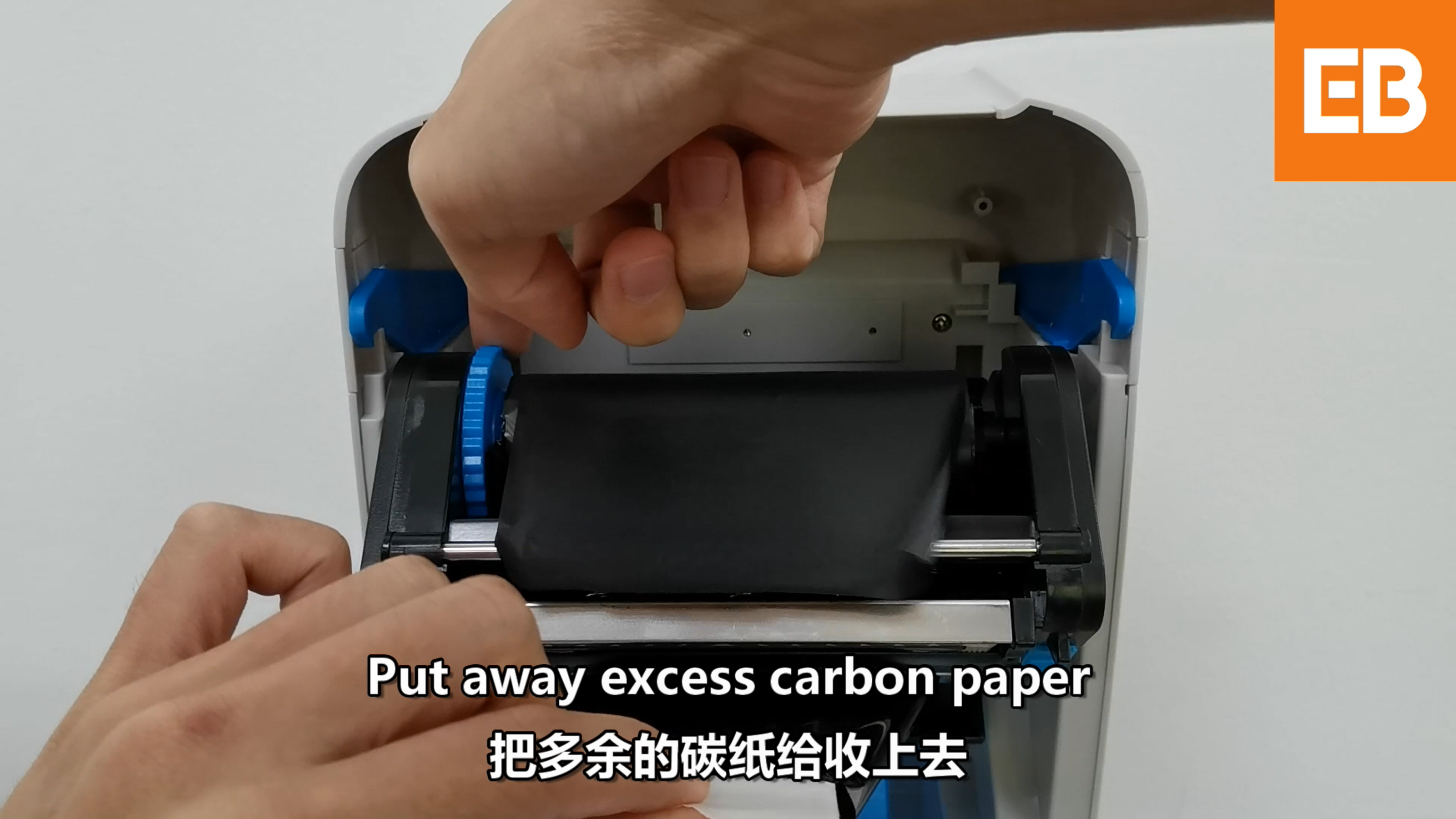 Wind the excess ribbon back onto the upper roll