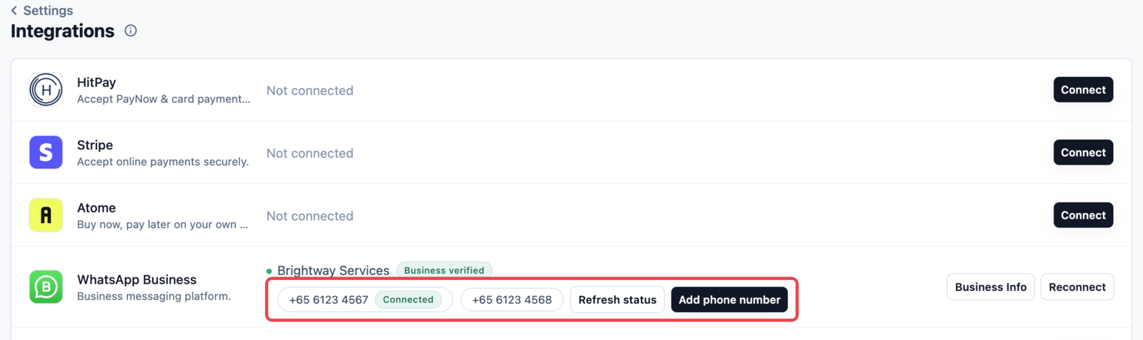 The WhatsApp Business row on the Integrations page, showing two numbers and the Add phone number button